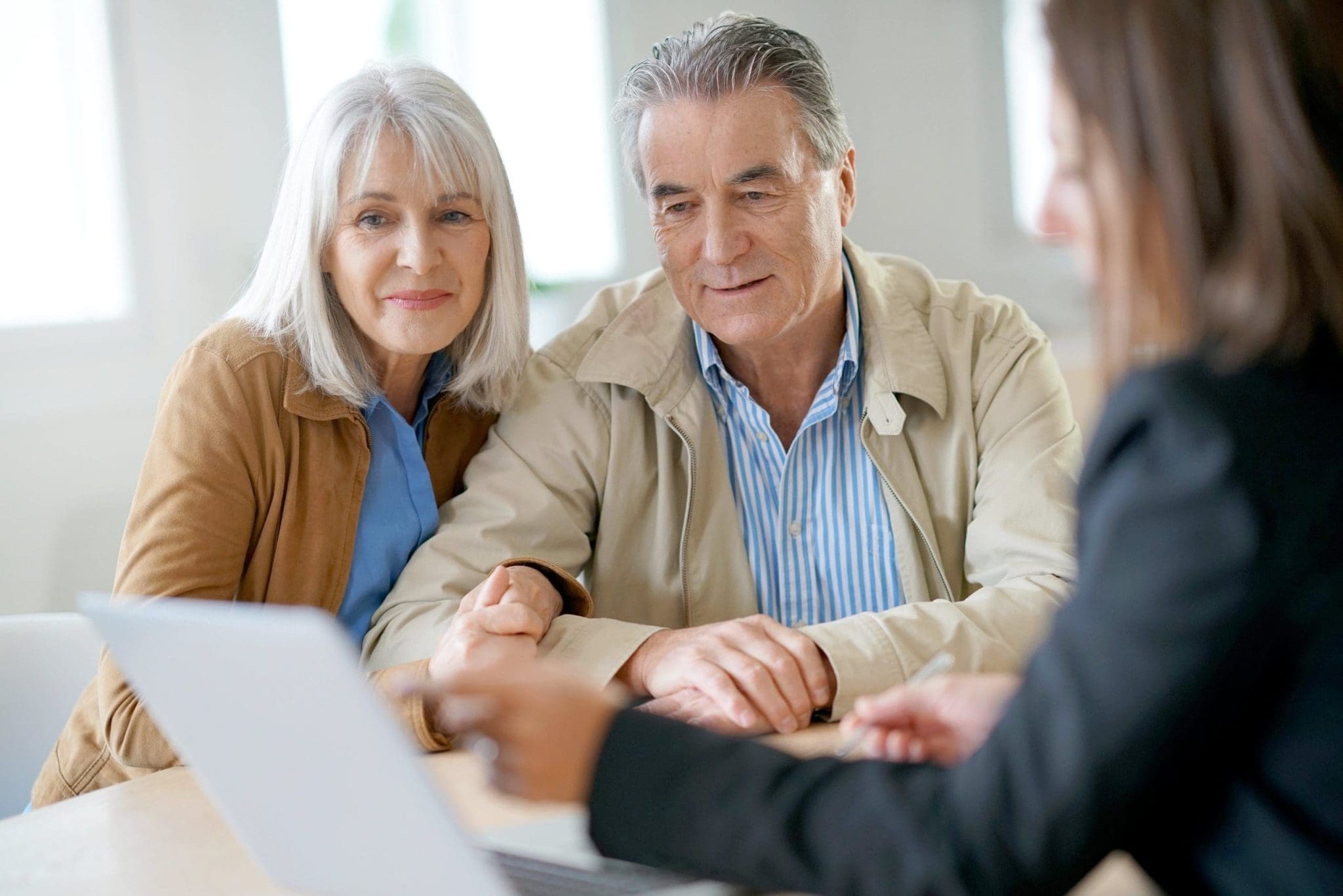 Older couple meeting with an independent financial adviser to discuss their long-term financial planning options.